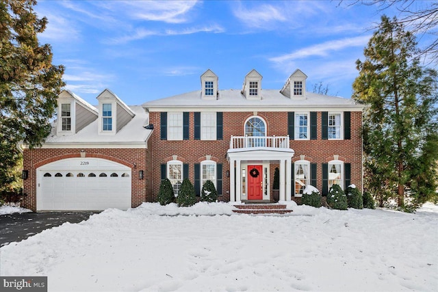 view of front of home with a balcony and a garage