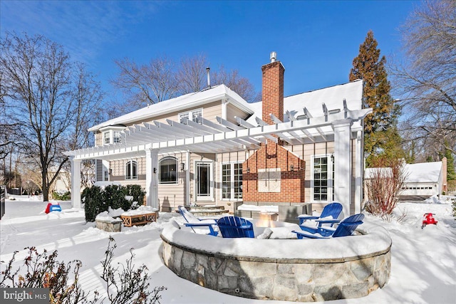 snow covered property featuring a pergola