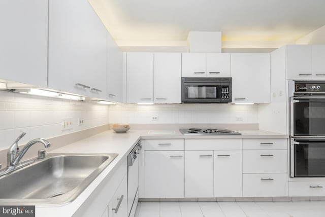 kitchen with sink, backsplash, white cabinetry, and black appliances