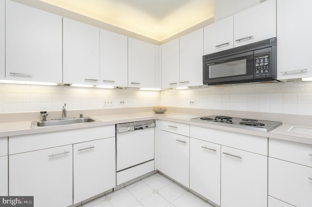 kitchen with white cabinets, white appliances, sink, and light tile patterned floors