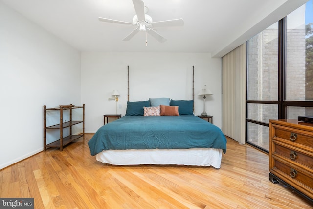 bedroom with light hardwood / wood-style flooring and ceiling fan