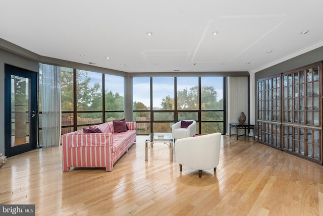 living room with floor to ceiling windows and light hardwood / wood-style flooring