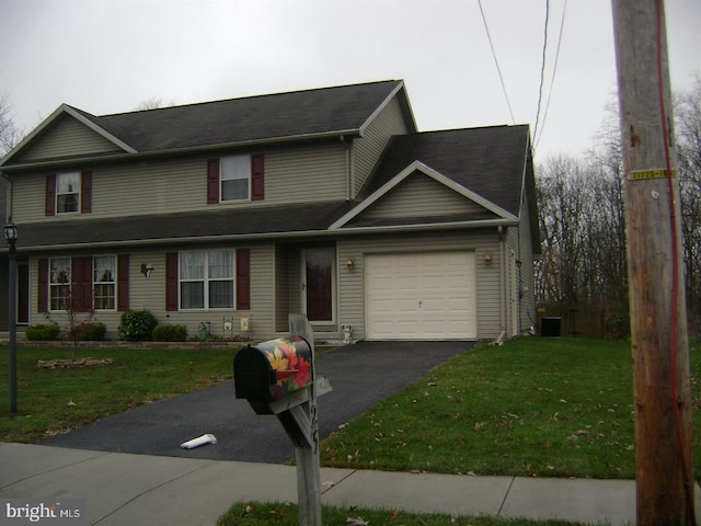 view of front of home featuring a front yard and a garage