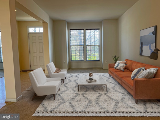 living room with carpet, plenty of natural light, and baseboards