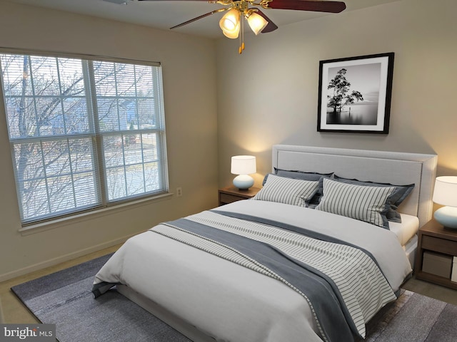 bedroom featuring a ceiling fan and baseboards