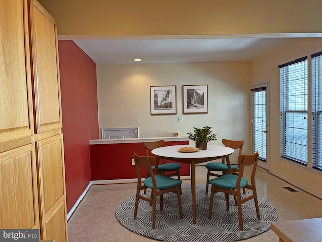 dining room featuring baseboards and visible vents