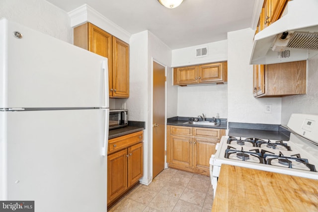 kitchen featuring sink and white appliances