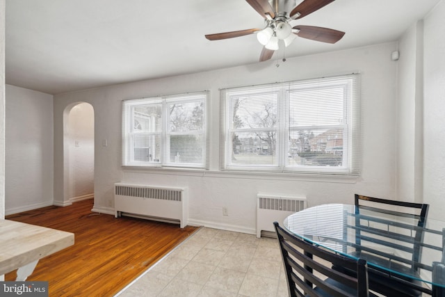 dining area with plenty of natural light, radiator, and light hardwood / wood-style floors