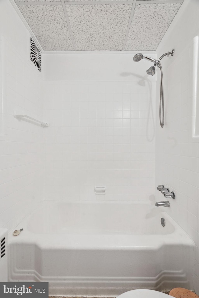 bathroom featuring toilet and tiled shower / bath combo