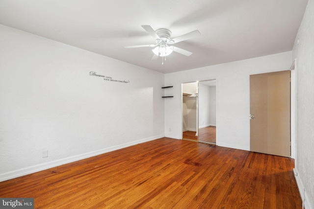 unfurnished bedroom featuring a closet, dark hardwood / wood-style floors, and ceiling fan