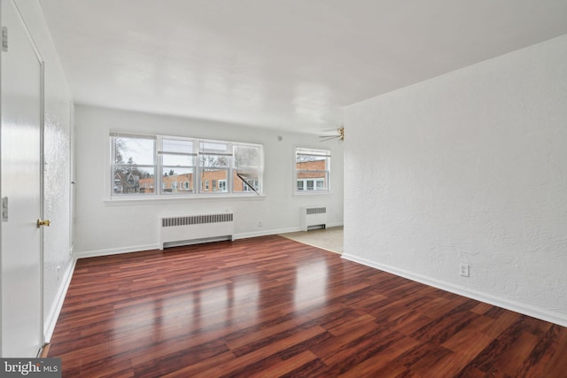 unfurnished living room with radiator, hardwood / wood-style floors, and ceiling fan