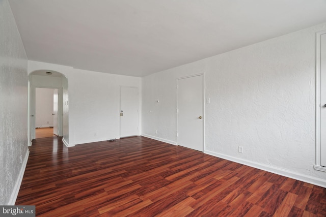 spare room featuring dark hardwood / wood-style floors