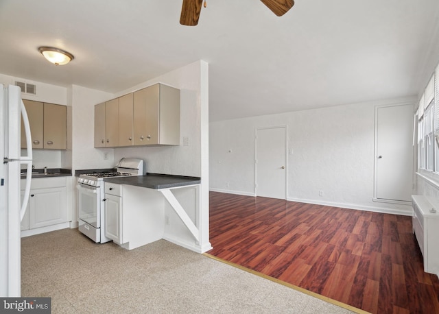 kitchen featuring ceiling fan, white appliances, sink, and hardwood / wood-style floors