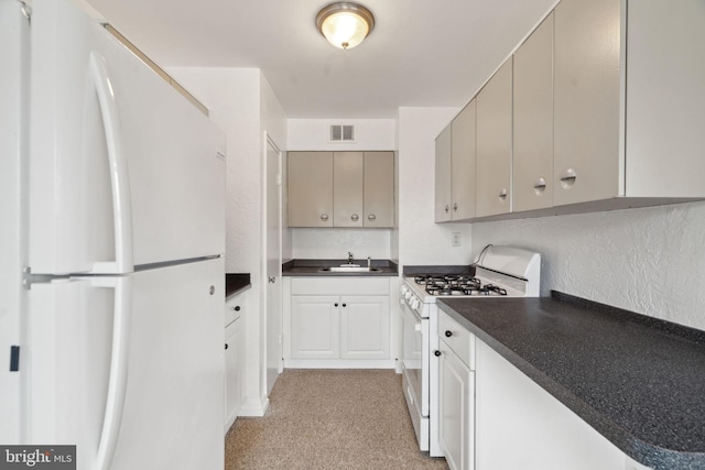 kitchen featuring sink, white appliances, and gray cabinets