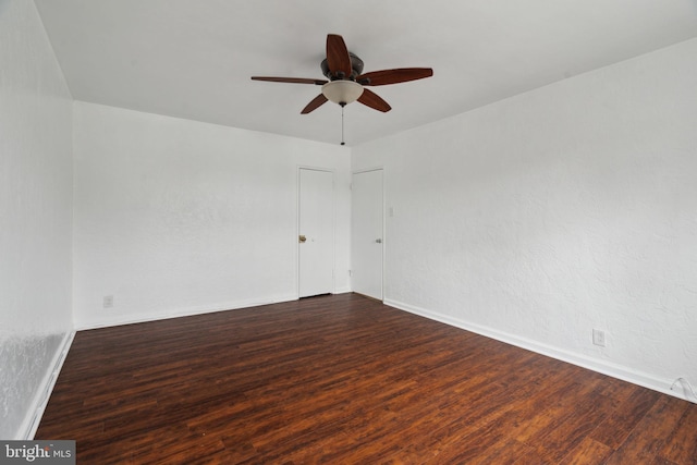 unfurnished room featuring ceiling fan and dark hardwood / wood-style flooring