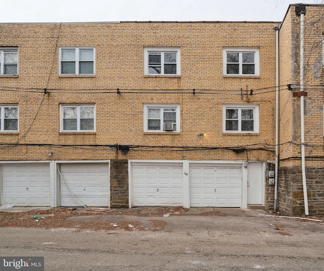 rear view of house with a garage