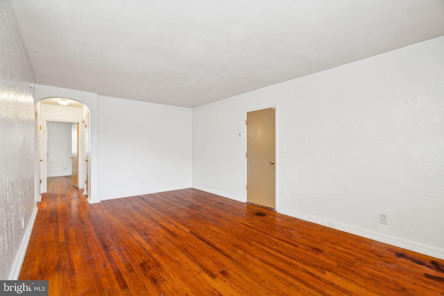 unfurnished room with wood-type flooring