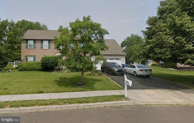 colonial house with a garage and a front lawn