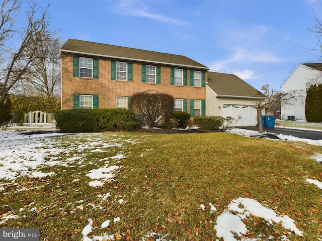 view of front of home with a lawn and a garage