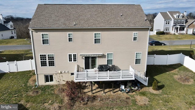 back of house with a lawn and a wooden deck