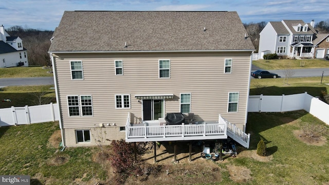 back of house with a lawn and a wooden deck