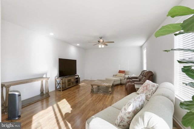 living room featuring light hardwood / wood-style floors and ceiling fan