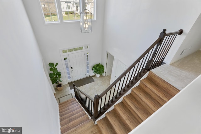 entryway featuring a chandelier and a high ceiling