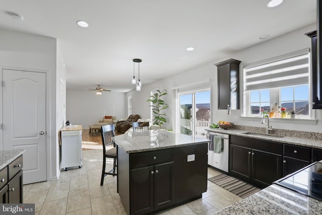 kitchen with ceiling fan, sink, a center island, stainless steel dishwasher, and pendant lighting