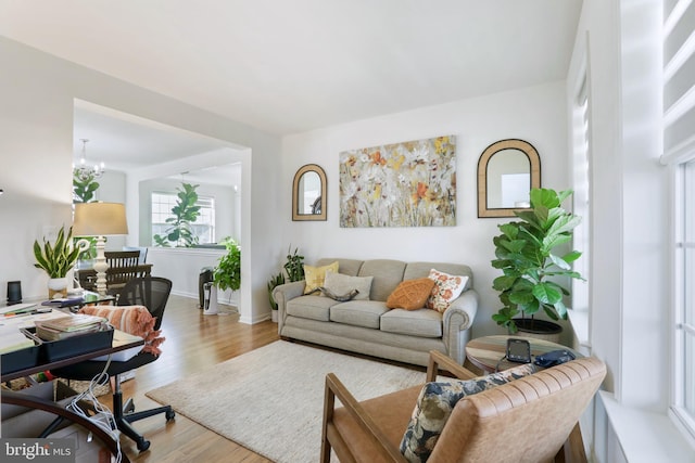 living room featuring light hardwood / wood-style floors and a notable chandelier