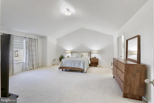 bedroom featuring light carpet and lofted ceiling