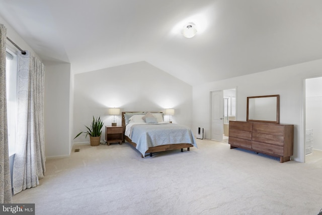 bedroom featuring light carpet, multiple windows, and lofted ceiling