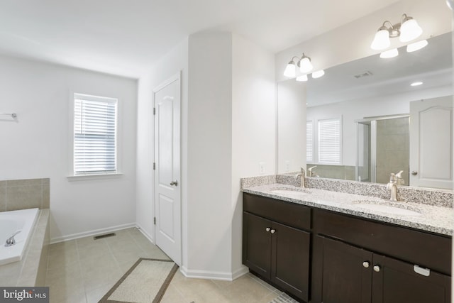 bathroom featuring tile patterned floors, vanity, and shower with separate bathtub