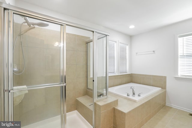 bathroom with tile patterned floors, shower with separate bathtub, and a wealth of natural light