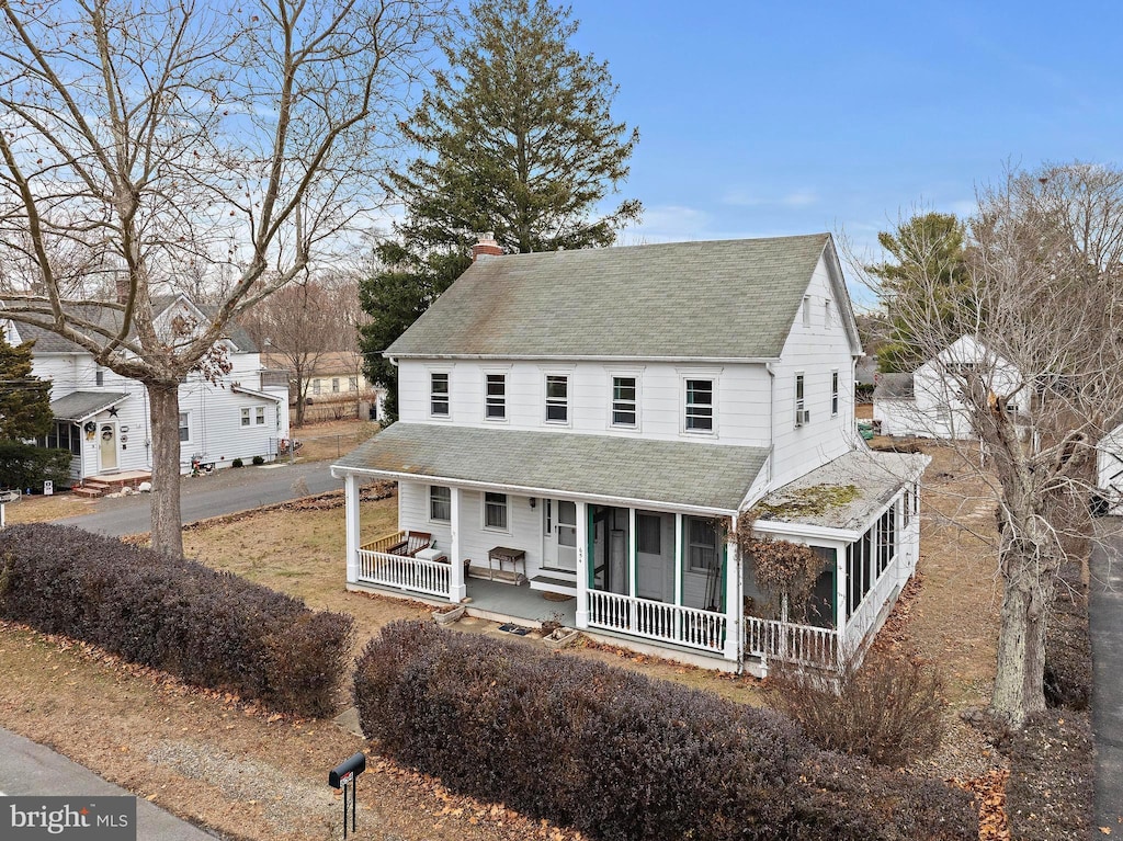 farmhouse featuring a sunroom and a porch