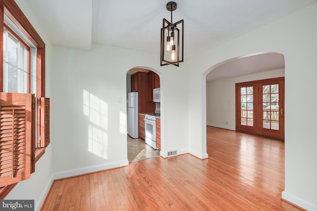 interior space with light hardwood / wood-style flooring and french doors