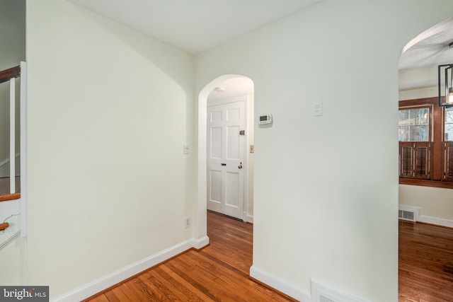 hall with hardwood / wood-style flooring