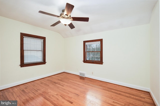 empty room with light hardwood / wood-style floors, vaulted ceiling, and ceiling fan