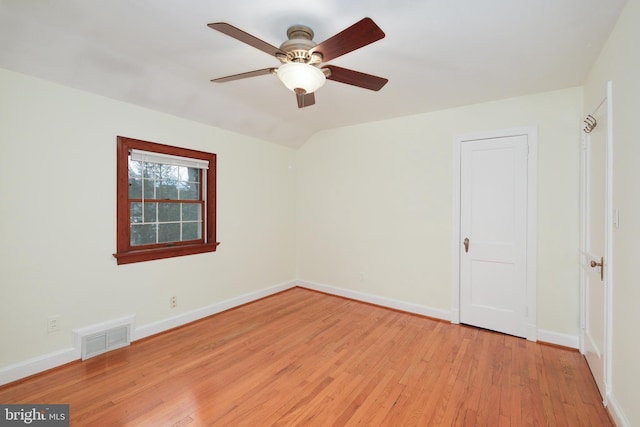 unfurnished room featuring ceiling fan, light hardwood / wood-style flooring, and vaulted ceiling