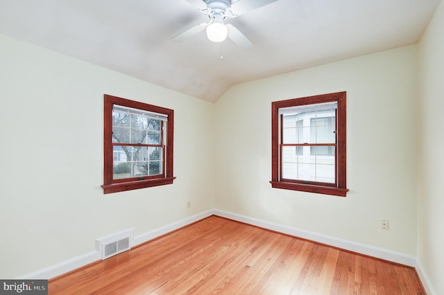 spare room featuring light hardwood / wood-style floors, lofted ceiling, and ceiling fan