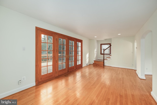 interior space featuring a wealth of natural light, french doors, and light wood-type flooring