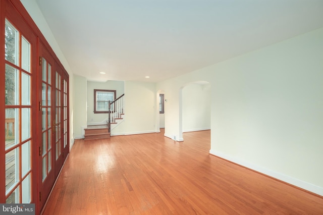 empty room featuring a healthy amount of sunlight and light hardwood / wood-style flooring