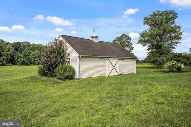 view of outbuilding featuring a yard