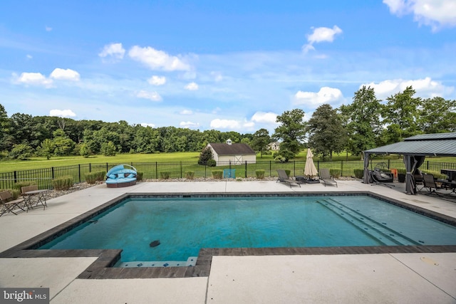 view of swimming pool featuring a gazebo and a patio