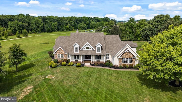 cape cod-style house featuring a front lawn and a porch