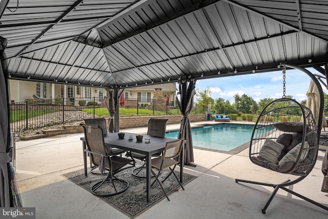 view of patio / terrace with a fenced in pool