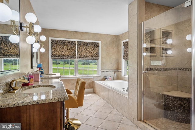 bathroom with plus walk in shower, vanity, and tile patterned flooring