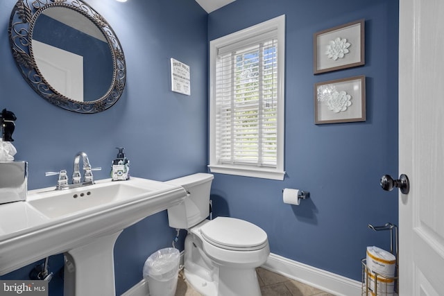 bathroom featuring toilet and tile patterned floors