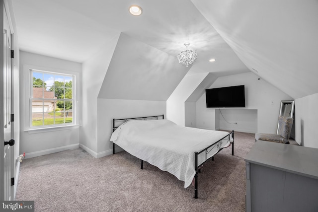 bedroom featuring a chandelier, carpet floors, and vaulted ceiling