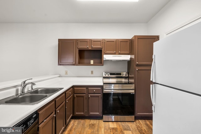 kitchen featuring dishwasher, sink, white refrigerator, dark wood-type flooring, and electric stove