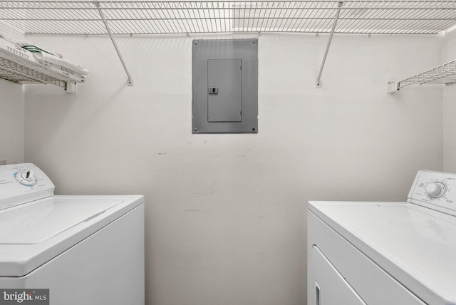 laundry room featuring electric panel and washer and dryer